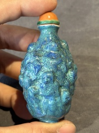 A rare Chinese robin's-egg-glazed moulded '18 Luohan' snuff bottle, 19th C.