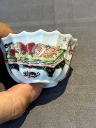A Chinese famille rose cup and saucer with a reclined lady, Qianlong