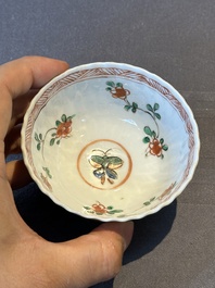 A pair of Chinese famille verte cafe-au-lait-ground cups and saucers, Kangxi