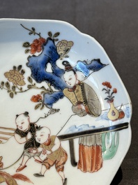 A Chinese polychrome cup and saucer with figures and a dog, Yongzheng