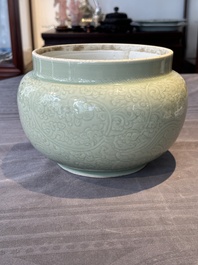 A Chinese monochrome celadon-glazed jar with anhua chilong and floral design, Kangxi