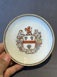 A pair of Chinese armorial famille rose cups and saucers with the arms of Tyndall for the English market and two monogrammed bowls, Qianlong
