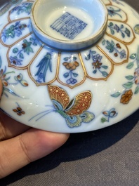 An exceptional Chinese gilt-decorated doucai and famille rose covered bowl with butterflies and floral design, Jiaqing mark and of the period