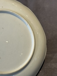 A Chinese polychrome cup and saucer with figures and a dog, Yongzheng