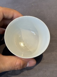 A Chinese famille rose cup and saucer with music making ladies, Yongzheng/Qianlong