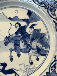 A pair of Chinese blue and white 'hunting scene' plates, Qi Yu Bao Ding Zhi Zhen 奇玉寶鼎之珍 mark, Kangxi