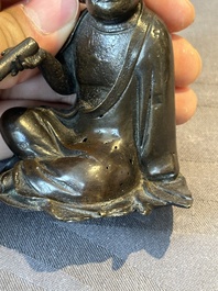 A small Chinese bronze figure of a Luohan, Ming