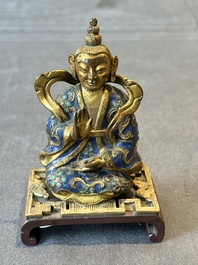 A Chinese gilt and champlev&eacute; enamelled bronze Bodhisattva on a carved stone stand, Qing