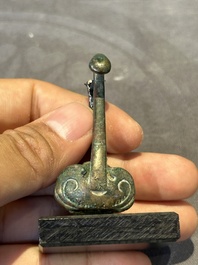 A varied collection of six Chinese bronze belt hooks, Warring States period and Western Han