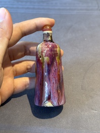 Two Chinese famille rose 'lotus scroll' snuff bottles and a flamb&eacute;-glazed snuff bottle, 19th C.