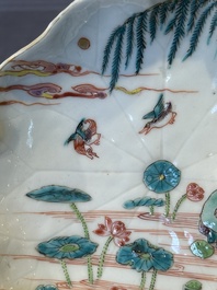 A Chinese famille rose relief-decorated 'lotus' cup and saucer, Yongzheng