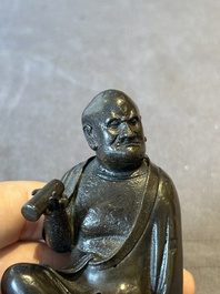 A small Chinese bronze figure of a Luohan, Ming