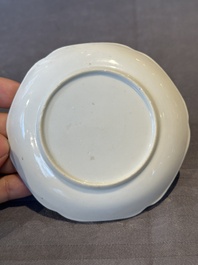 A Chinese polychrome cup and saucer with figures and a dog, Yongzheng