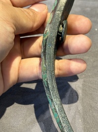 A varied collection of six Chinese bronze belt hooks, Warring States period and Western Han
