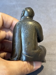 A small Chinese bronze figure of a Luohan, Ming