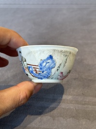 A Chinese famille rose cup and saucer with music making ladies, Yongzheng/Qianlong
