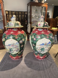 A pair of Chinese famille rose black-ground jars and covers with mountainous landscape design, Yongzheng