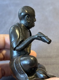 A small Chinese bronze figure of a Luohan, Ming