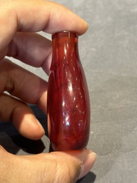 A group of seven Chinese red-overlay glass and red glass snuff bottles, 19/20th C.