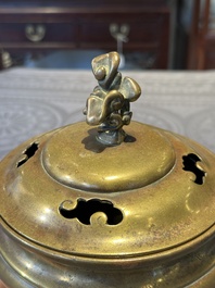 A Chinese bronze tripod censer with cover and stand, 19th C.