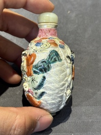 Eight Chinese moulded famille rose snuff bottles, Qianlong mark, 19th C.