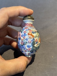 Six Chinese moulded famille rose snuff bottles, Qianlong mark, 19th C.