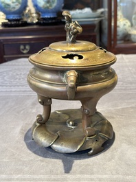 A Chinese bronze tripod censer with cover and stand, 19th C.