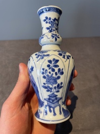 A Chinese blue and white vase, a covered bowl and six saucers, Chenghua and artemisia leaf mark, Kangxi