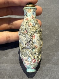 Eight Chinese moulded famille rose snuff bottles, Qianlong mark, 19th C.