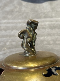 A Chinese bronze tripod censer with cover and stand, 19th C.