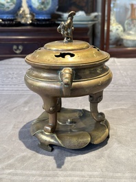 A Chinese bronze tripod censer with cover and stand, 19th C.