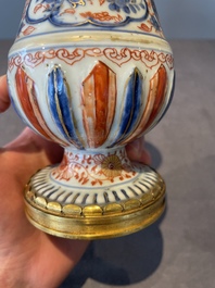 A pair of Chinese Imari-style casters or vases with gilt bronze mounts, Kangxi