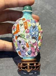 Eight Chinese moulded famille rose snuff bottles, Qianlong mark, 19th C.