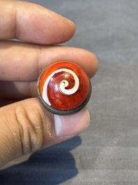 A Chinese blue, white and copper-red snuff bottle, 19th C.