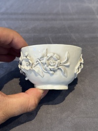 A Chinese blue and white 'butterfly' cup and saucer with applied floral design, Qianlong