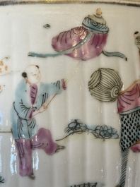 A pair of Chinese famille rose jars and covers with figures in a garden, Tongzhi mark and of the period