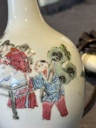 A pair of Chinese famille rose vases with figural design mounted as lamps, 19th C.