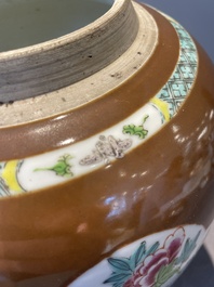 A pair of Chinese capucin-brown-ground famille rose covered jars with floral design, Yongzheng/Qianlong