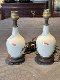 A pair of Chinese famille rose vases with figural design mounted as lamps, 19th C.