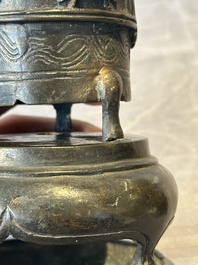 Two Chinese Chinese bronze cylindrical incense stick holders and a covered censer, Yuan/Ming and Qing