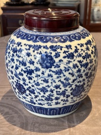 A Chinese blue and white 'flower scroll' jar with a wooden cover, Qianlong