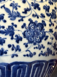 A Chinese blue and white 'flower scroll' jar with a wooden cover, Qianlong