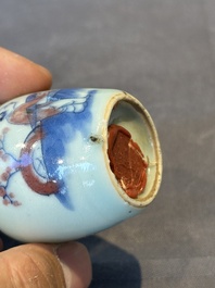 A Chinese blue, white and copper-red snuff bottle, 19th C.