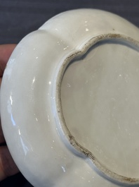 A Chinese blue and white 'butterfly' cup and saucer with applied floral design, Qianlong