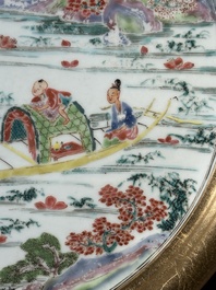 A Chinese famille rose plate with figures in a river landscape in gilt wooden frame, Yongzheng