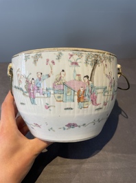 A pair of Chinese famille rose jars and covers with figures in a garden, Tongzhi mark and of the period