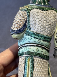 A fine Chinese verte biscuit figure of a warrior on wooden stand, Kangxi