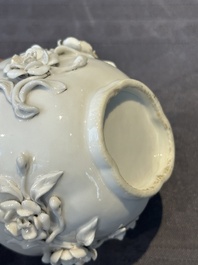 A Chinese blue and white 'butterfly' cup and saucer with applied floral design, Qianlong