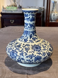 A Chinese blue and white 'lotus scroll' bottle vase, 18/19th C.