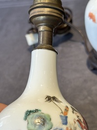 A pair of Chinese famille rose vases with figural design mounted as lamps, 19th C.